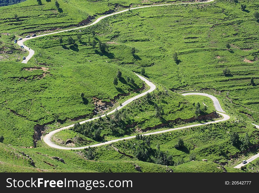 Green grassland and road in great mountain. Green grassland and road in great mountain