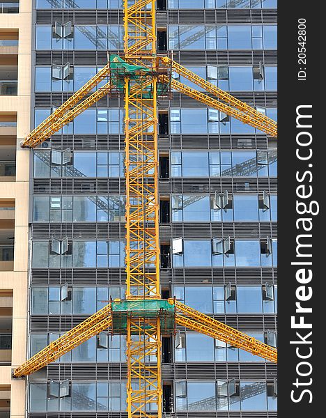 Modern buildings with external glass wall, under construction, shown as modern architecture construction and working place and equipment. Modern buildings with external glass wall, under construction, shown as modern architecture construction and working place and equipment.