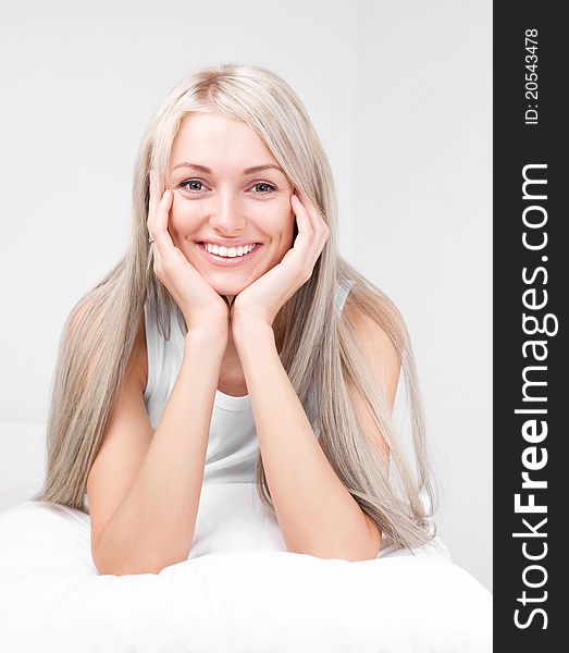 Beautiful young blond woman on the bed at home. Beautiful young blond woman on the bed at home