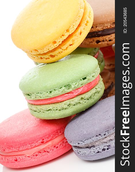 A french sweet delicacy, macaroons variety closeup. White background. A french sweet delicacy, macaroons variety closeup. White background.