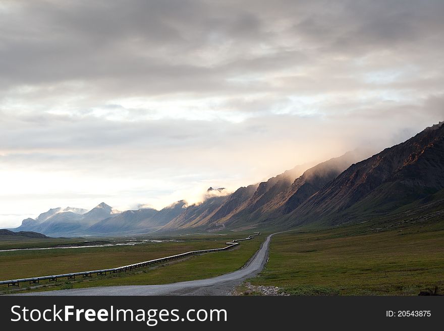 Pipeline along side Dalton highway leading to mountain near Sukakpak Mountain, Alaska. Pipeline along side Dalton highway leading to mountain near Sukakpak Mountain, Alaska