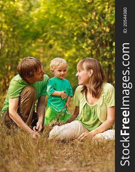 Happy young family with baby in summer nature. Happy young family with baby in summer nature