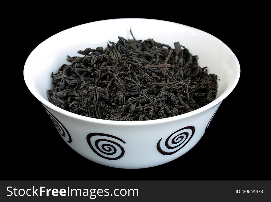 Black tea leaves of Sri Lanka isolated over black background