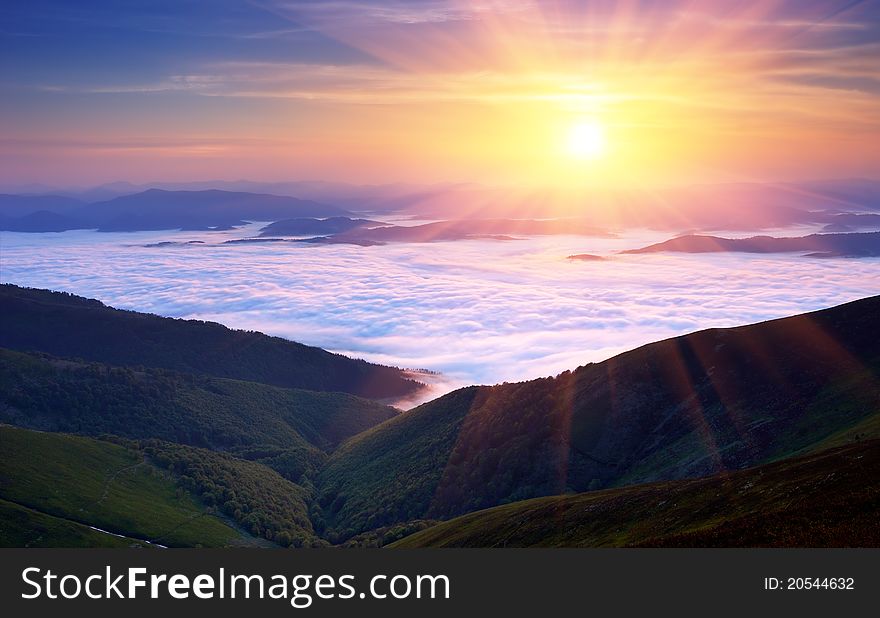 Summer landscape in mountains with the sun