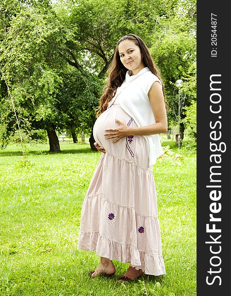 Pregnant Young Woman smile in summer park