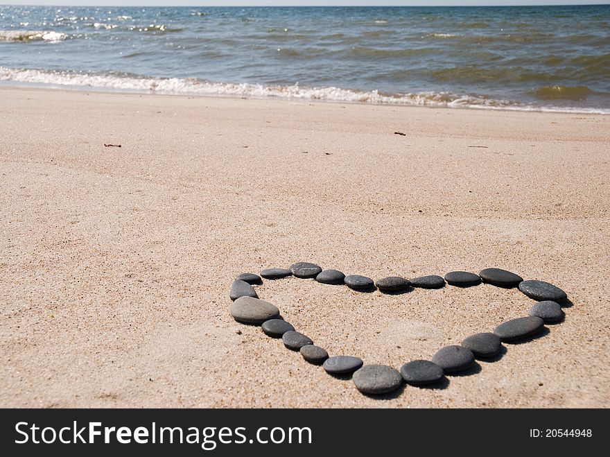 Heart from stones on beach