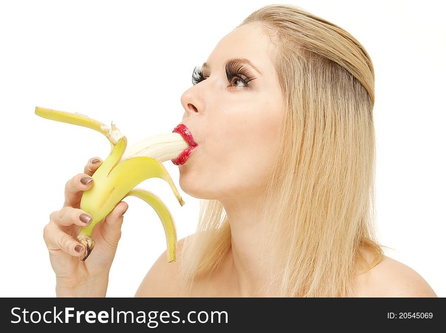 Portrait of attractive Blond woman with lengthen eyelashes sucking banana with red lips, isolated on white. Portrait of attractive Blond woman with lengthen eyelashes sucking banana with red lips, isolated on white