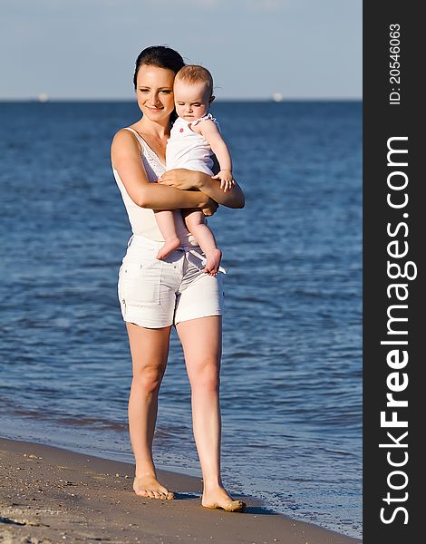 Happy mother and baby on beach