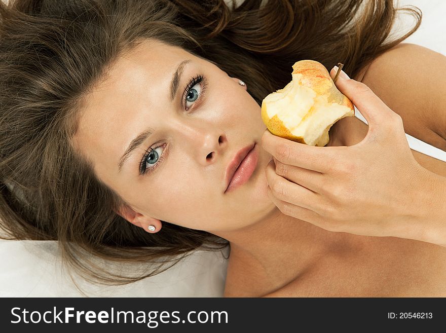 Young beautiful woman eatting a sweet apple. Young beautiful woman eatting a sweet apple