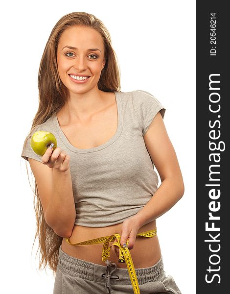 Closeup portrait of a charming woman with apple and measuring  her waist over white background. Closeup portrait of a charming woman with apple and measuring  her waist over white background
