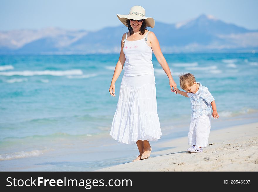 Young mother with her son on beach vacation