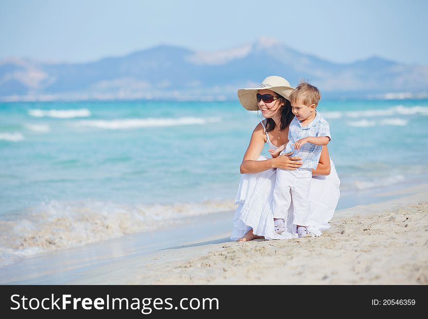 Young mother with her son on tropical beach vacation. Young mother with her son on tropical beach vacation