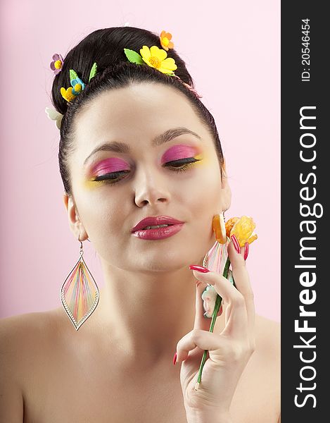 Close-up portrait of beautiful brunette with glamor make-up and color candy style