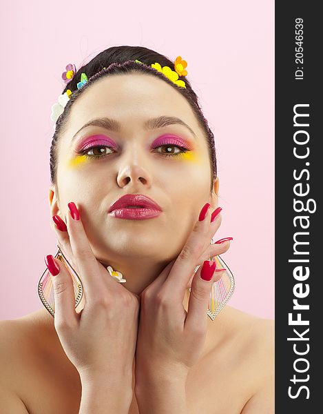 Close-up portrait of beautiful brunette with glamor make-up and color candy style