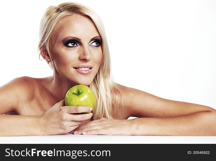 Beautiful blond woman holding green apple. Beautiful blond woman holding green apple