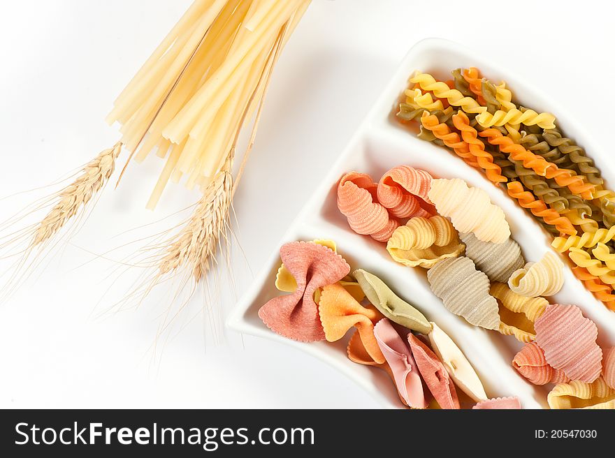 Different kinds of italian pasta on white background