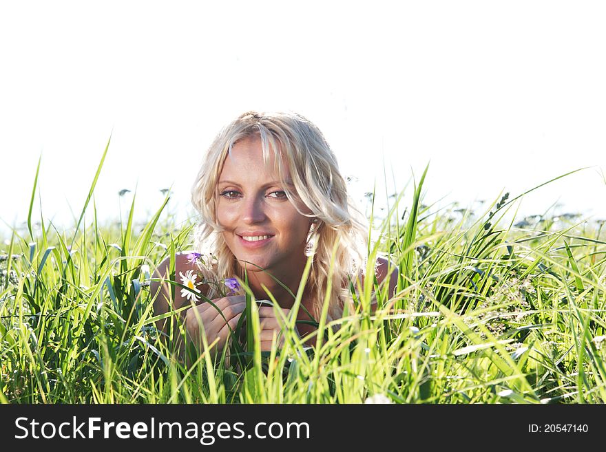 Woman on green grass close up