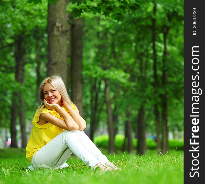 Happy woman sitting on grass. Happy woman sitting on grass