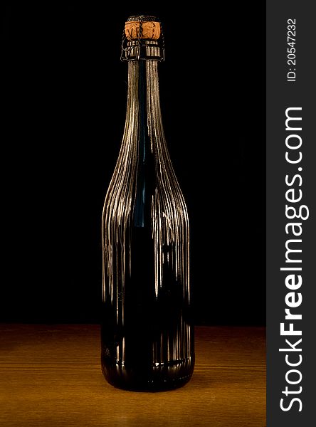 Wine Bottle with stripes of light on dark background