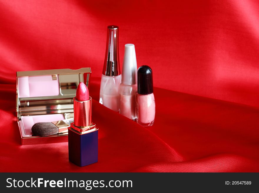Still life with cosmetics set on red silk. Still life with cosmetics set on red silk