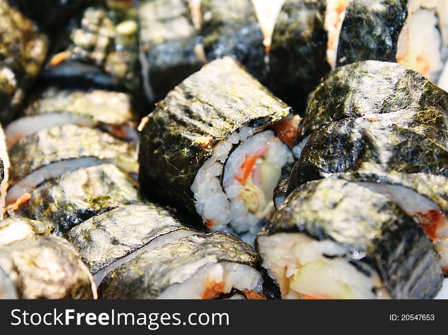 Plate of sushi, over bamboo background.