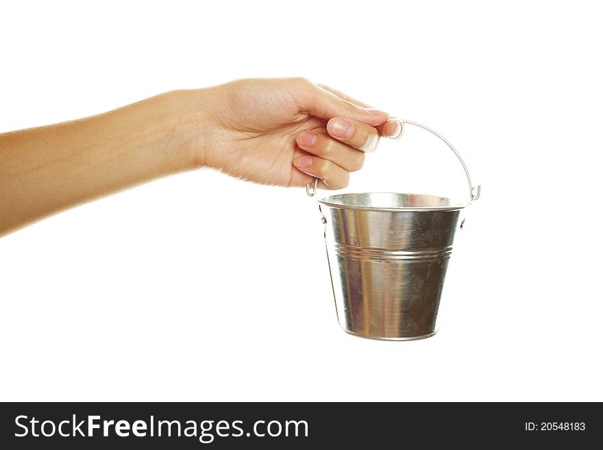 Close-up of female hand with an iron bucket. Isolated on a white background. Close-up of female hand with an iron bucket. Isolated on a white background
