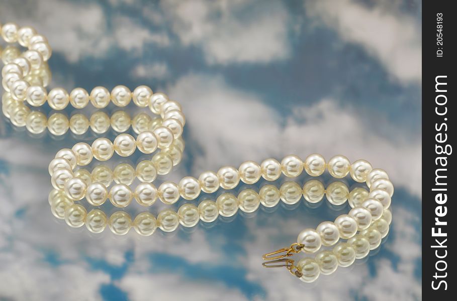 Elegant pearls with sky and reflection very shallow depth of field