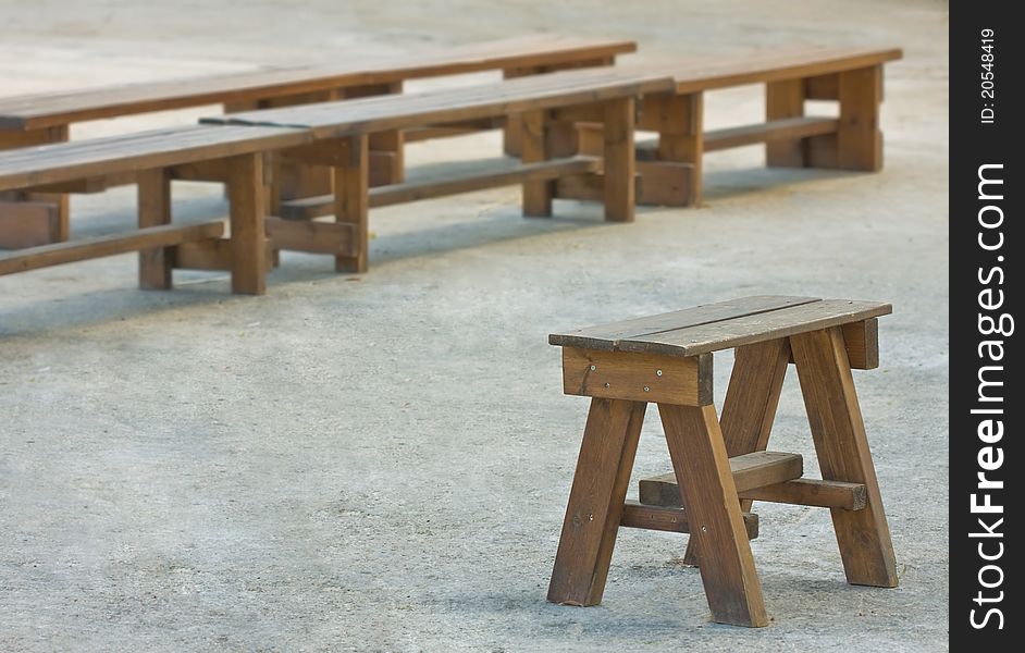 Concept - one chair for a leader in front of group benches. Concept - one chair for a leader in front of group benches