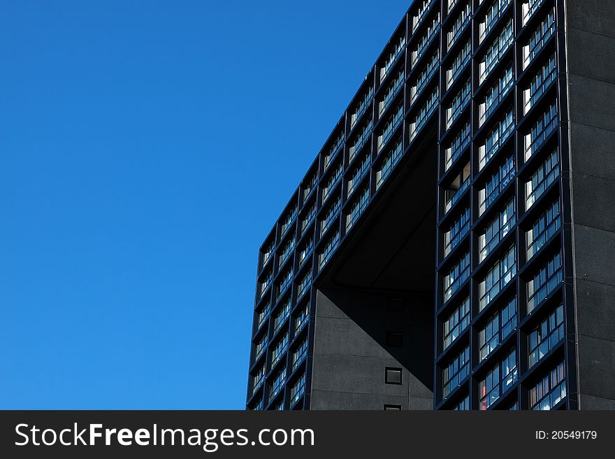 Fragment of modern building over bright blue sky. Fragment of modern building over bright blue sky