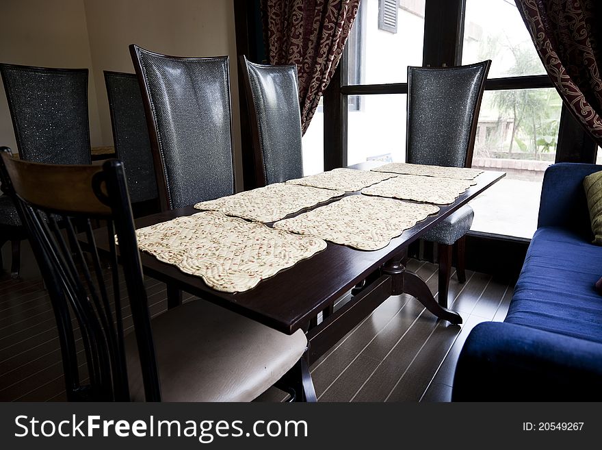 Dining table agaisnt a window with curtains
