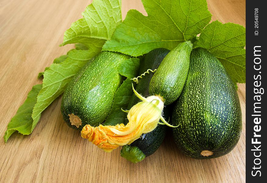 Marrows with green leaves on the table