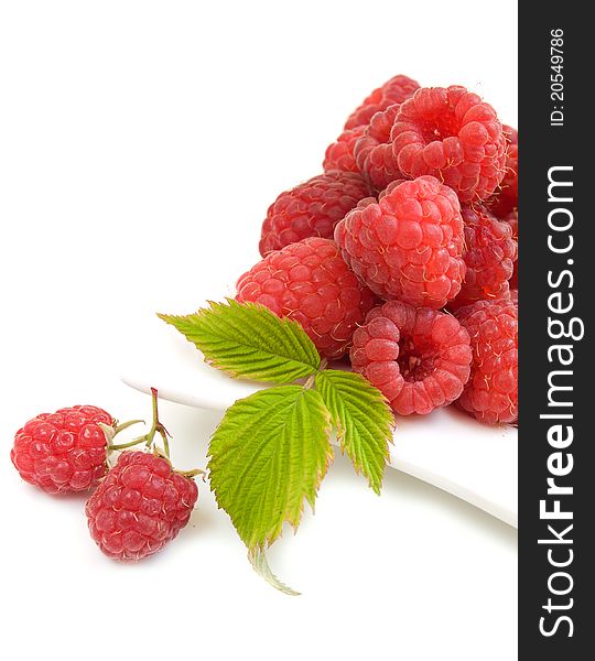 Raspberries on the plate on a white background