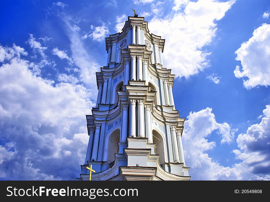 A belttower of a cathedral against the cloudy sky. A belttower of a cathedral against the cloudy sky.