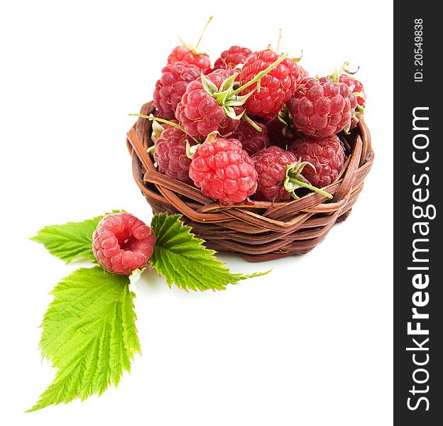 Raspberries with green leaves on a white background