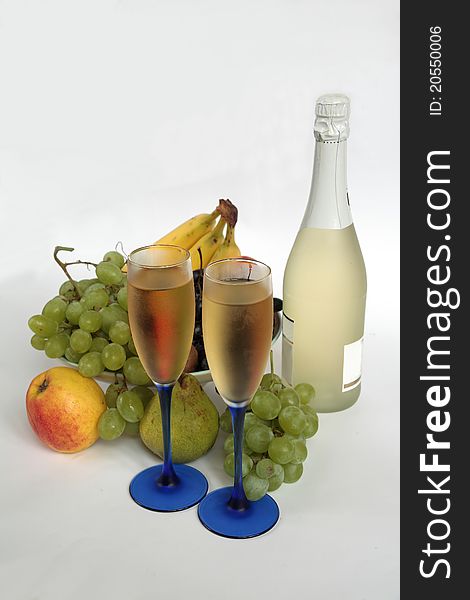 Champagne in glasses, bottle,grapes,apple,pear and banana. Champagne in glasses, bottle,grapes,apple,pear and banana.