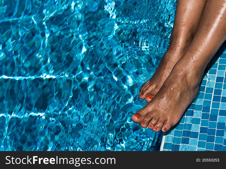 Female feet in pool