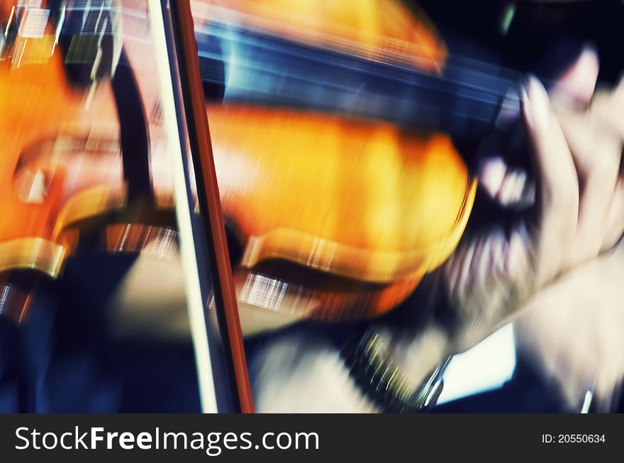 Closeup of blurred violin player in show. Closeup of blurred violin player in show