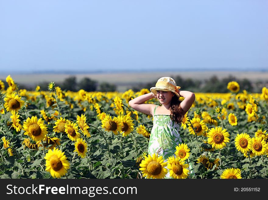 The girl and sunflowers in the field