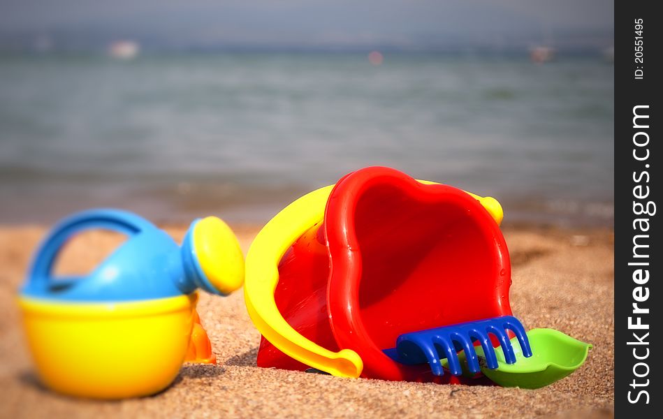 Children's toys on the beach on sea background