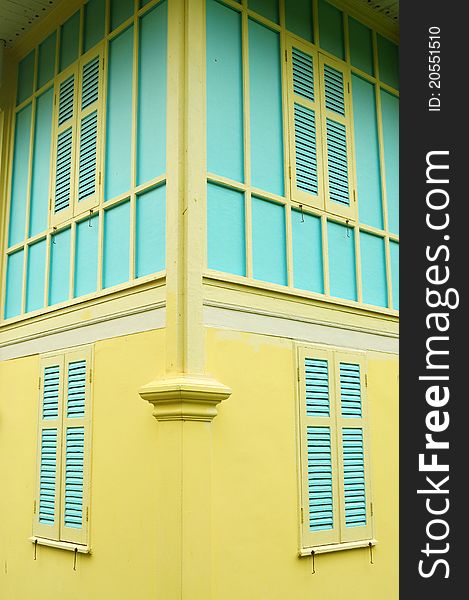 Blue windows on yellow wall in classic building. Blue windows on yellow wall in classic building.