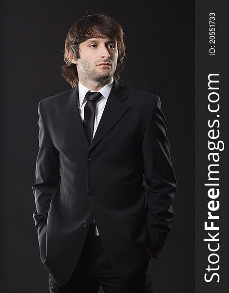 Handsome young man in business suit, studio photo