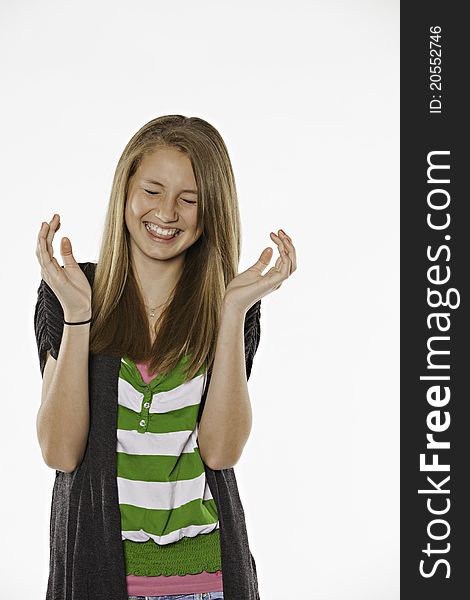 A happy laughing teenage female girl against a white background. A happy laughing teenage female girl against a white background