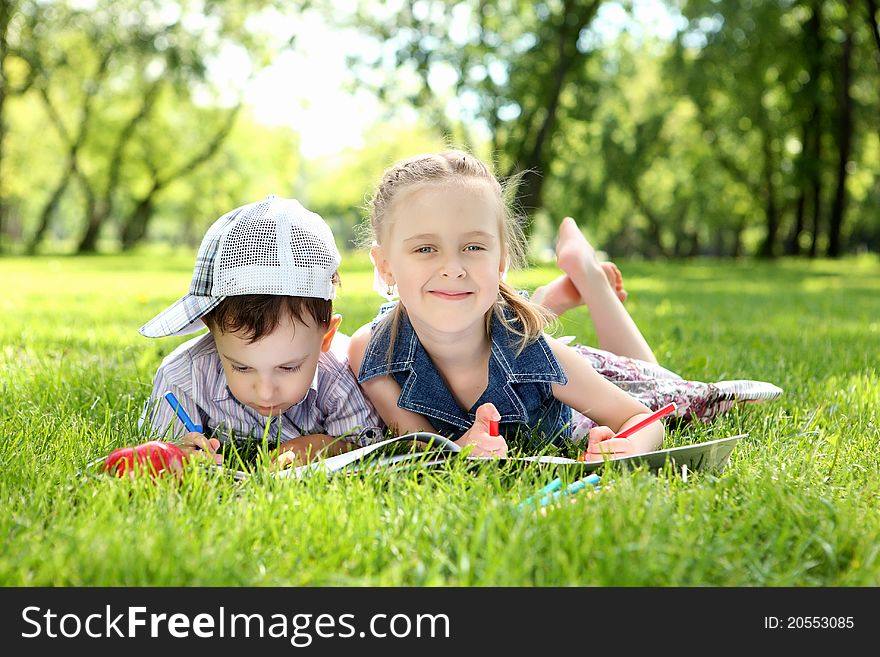 Sister and brother in the park reading a book. Sister and brother in the park reading a book