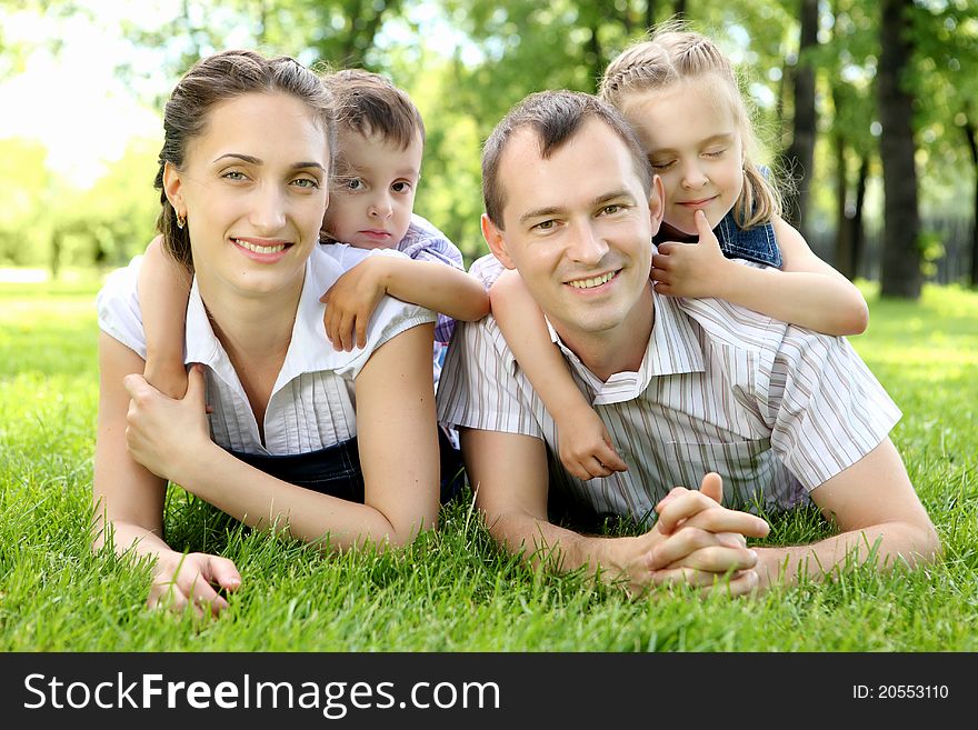 Family of mother, father and children together in the park. Family of mother, father and children together in the park