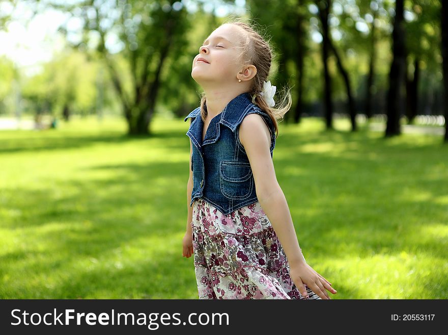 Portrait of a little girl standing in the park. Portrait of a little girl standing in the park
