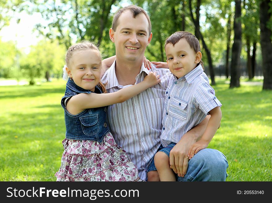 Father with son and daugther  together in the park. Father with son and daugther  together in the park