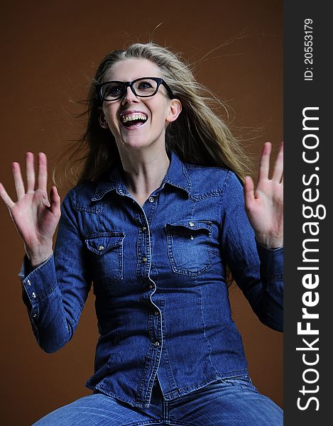 Happy woman in glass on the brown background