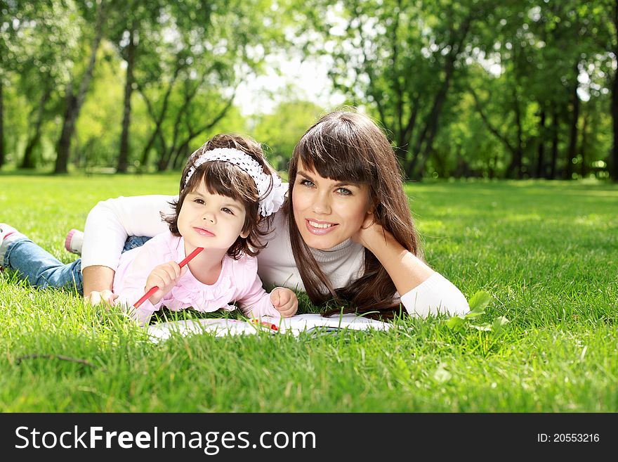 Mother with her daughter outside in the summer park