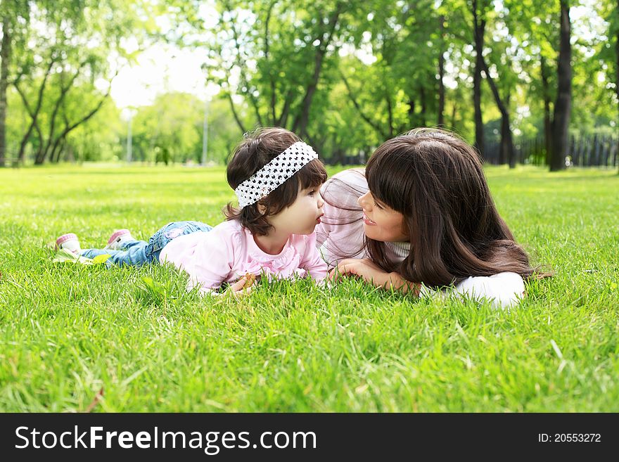 Mother with her daughter outside in the summer park