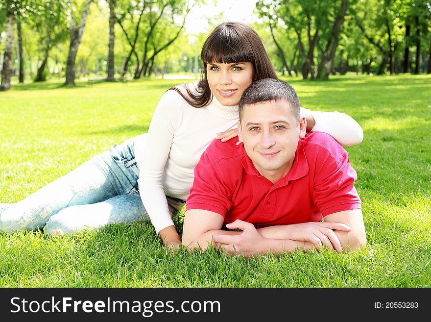 Romantic couple spending time together in the summer park. Romantic couple spending time together in the summer park